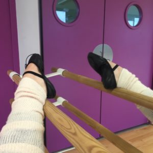 A leg stretching at the barre.