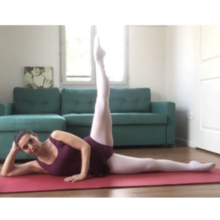 A woman doing floor barre