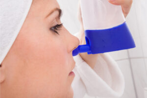 Immunity boost-young woman cleaning nose