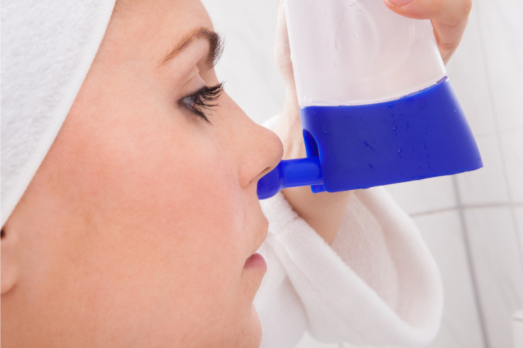 Immune system-young woman cleaning nose