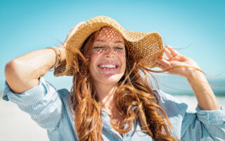 Immunity boost-woman with a summer hat soaking in sunlight