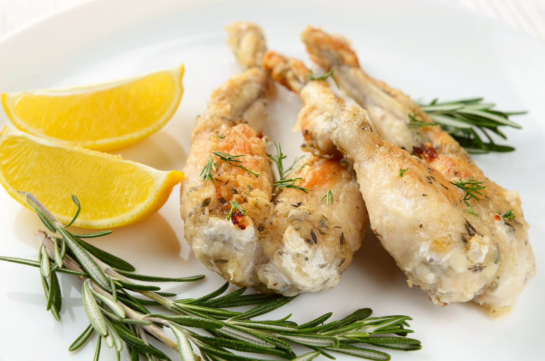 weird French Christmas traditional dish-frog legs fried with garlic and herbs and lemon