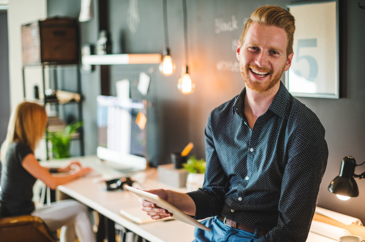 What-is-eustress-happy-businessman-working-on-digital-tablet-in-office