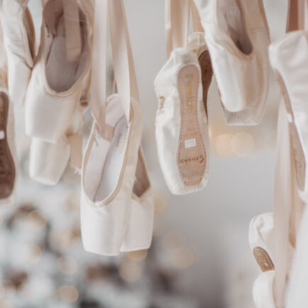 ballet lovers gift ideas-a group of hanging ballerina pointe shoes for decoration