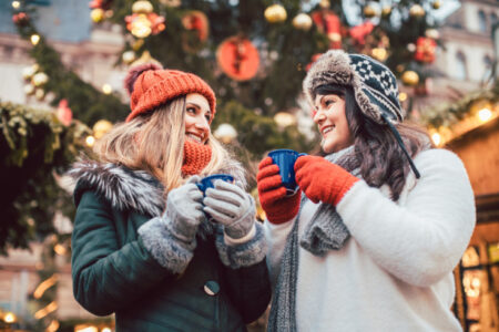 healthy and fit over Christmas-best friends enjoying mulled wine at the Christmas market