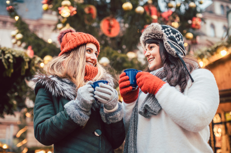 healthy and fit over Christmas-best friends enjoying mulled wine at the Christmas market