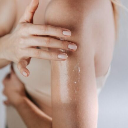 French winter body skincare-Woman applying moisturizing cream on her skin