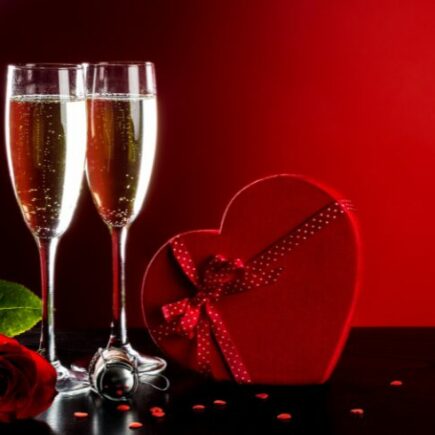 Valentines-day-in-france-traditions-champagne-red-rose-heart-shaped-box-background