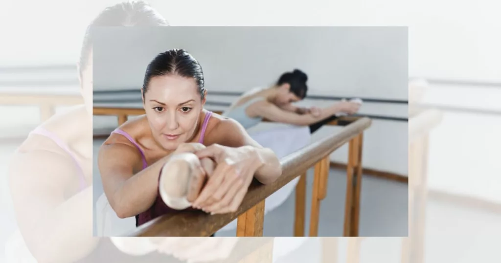 Ballerina doing a hamstring stretch at the barre