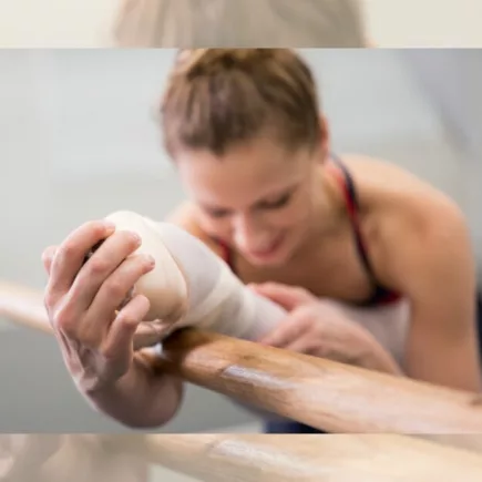 Ballet dancer stretching at the barre