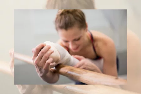 Ballet dancer stretching at the barre