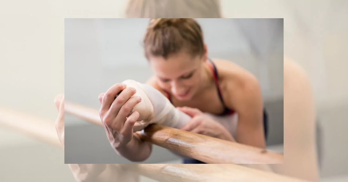 Ballet dancer stretching at the barre