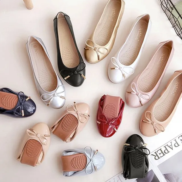 several pairs of ballet flats of different colors and several ones that are folded